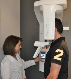 Dr. Tappuni gets ready to acquire a
					panoramic X-ray.